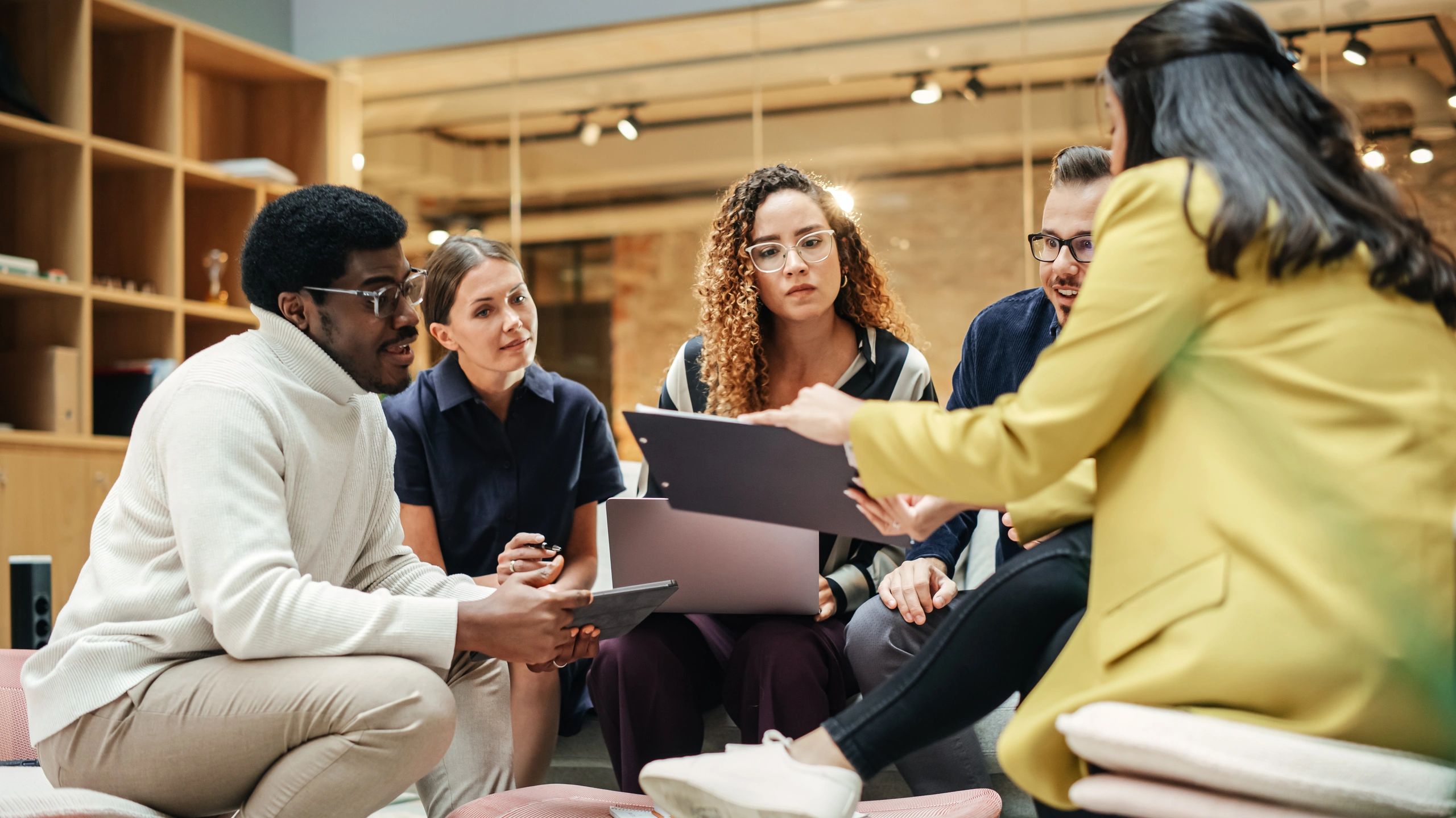Supportive workplace team collaborating in a modern meeting room
