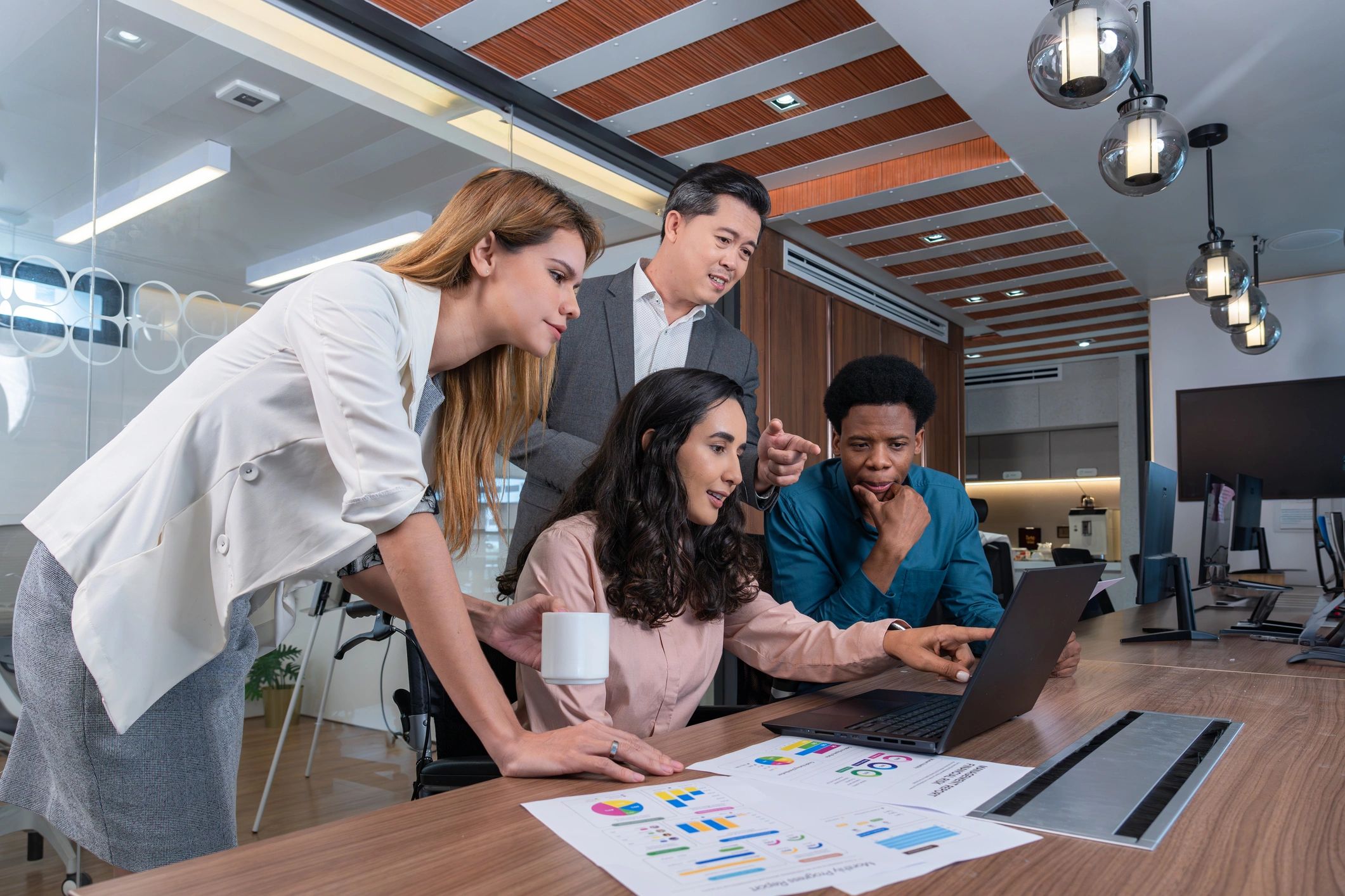 Small group collaborating around a table in a modern office
