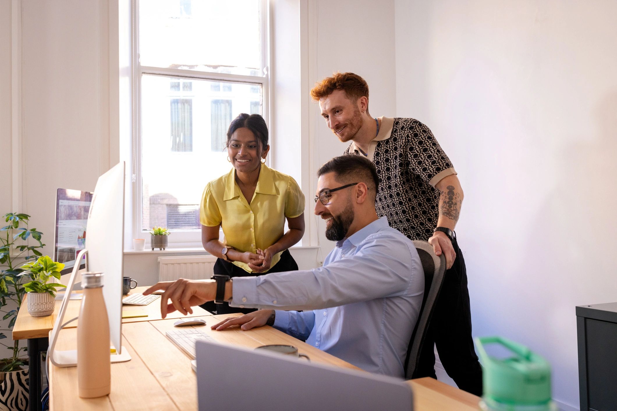 Workplace training discussion around a computer
