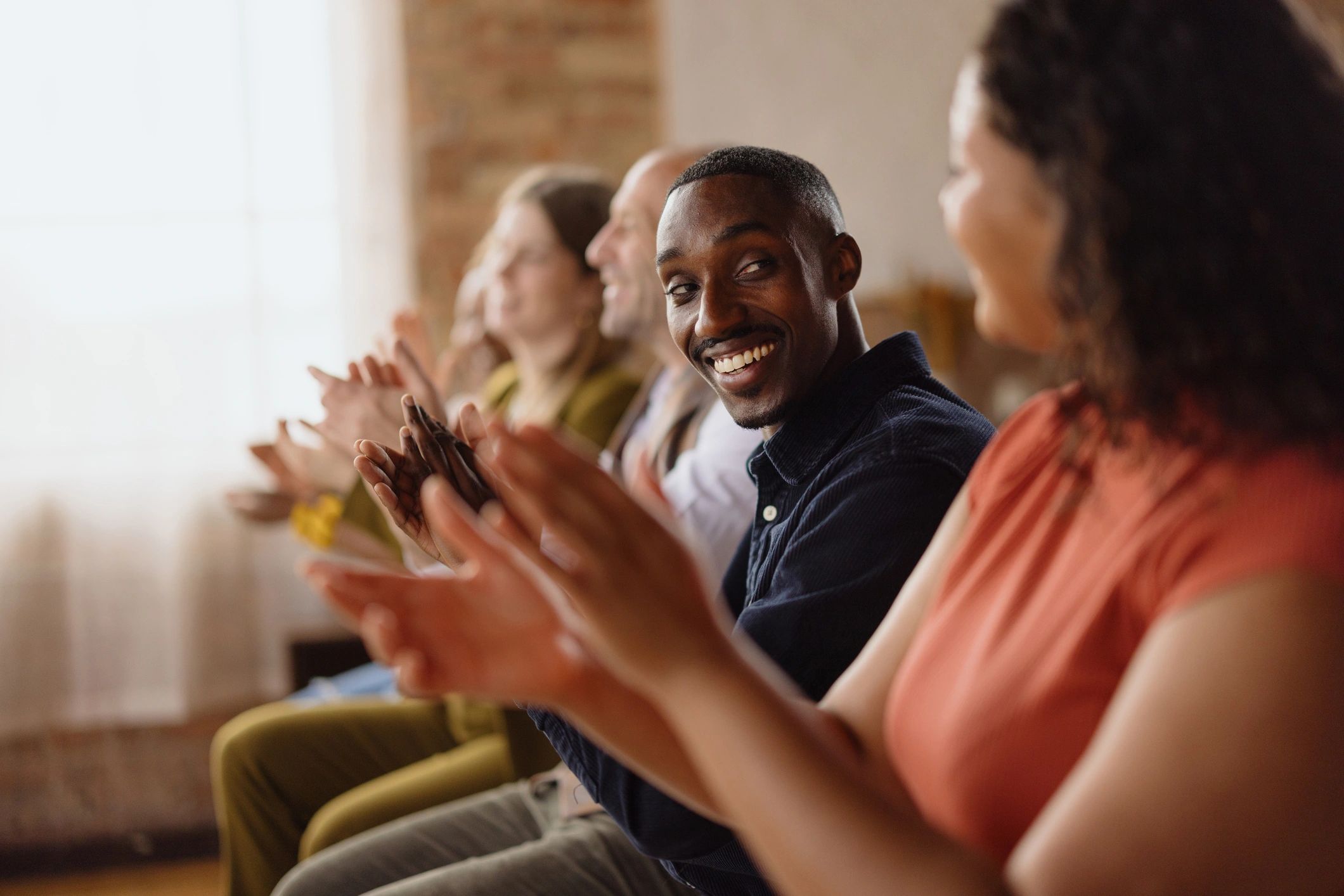 Supportive audience applauding at a professional event